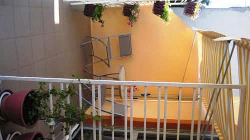 a spiral staircase with a surfboard in a building at Friendly People's Guest House in Zadar