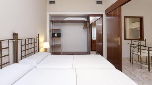 Posteľ alebo postele v izbe v ubytovaní Apartamentos Vértice Bib Rambla