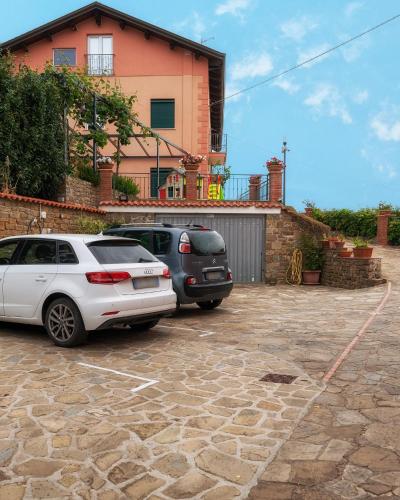 two cars parked in a parking lot in front of a house at Casa Vittoria in Agropoli