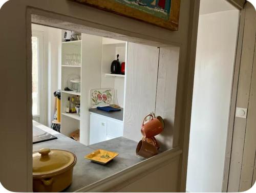 un miroir reflétant une cuisine avec un comptoir dans l'établissement Maison spacieuse hyper centre - 5à7p - Terrasse privée, à Les Sables-dʼOlonne