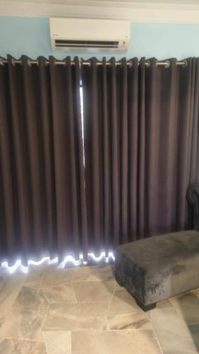 a black curtain in a room with a bed at PD WORLD MARINa in Port Dickson