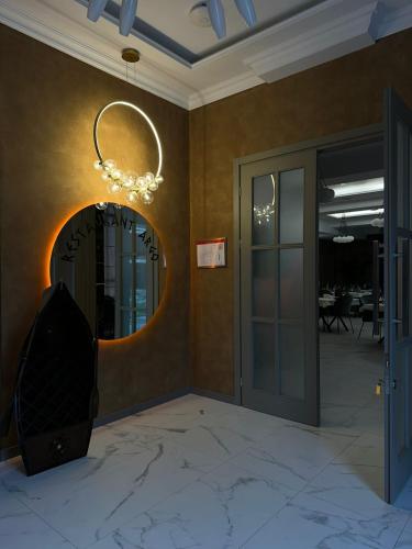 a hallway with a round mirror and a door at Astana Palace in Gori