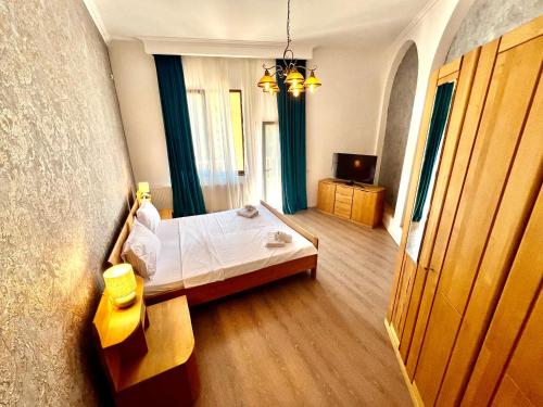a bedroom with a bed and a room with a window at Catedrala Blue in Constanţa