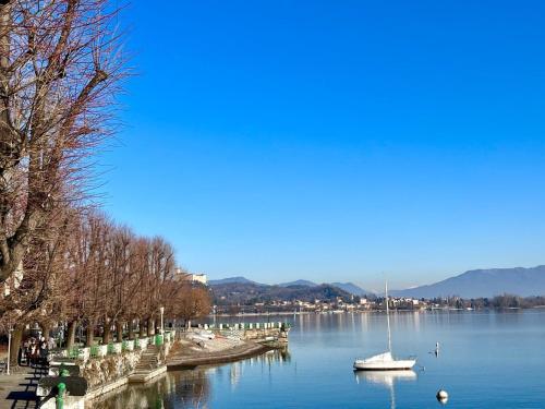 a sailboat is docked at a dock on a lake at Gemelli al Lago in Arona