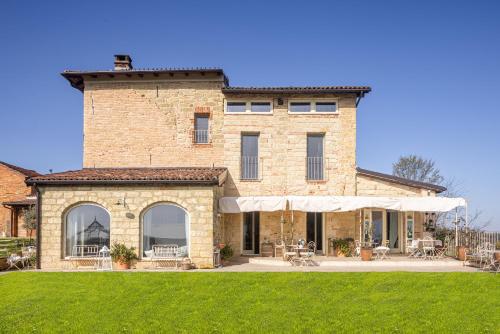 a large brick building with a tower on top at Le libellule relais in San Lorenzo