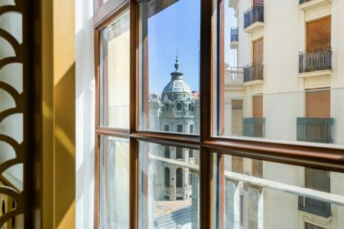 a view of a building through a window at Grand Hotel Centenari, Valencia, Autograph Collection in Valencia