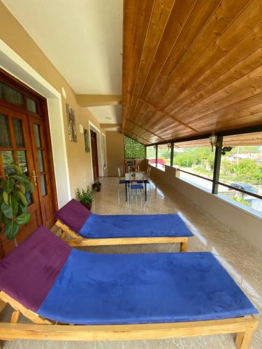 a room with two beds with blue sheets at Guesthouse Hoxholli in Gramsh