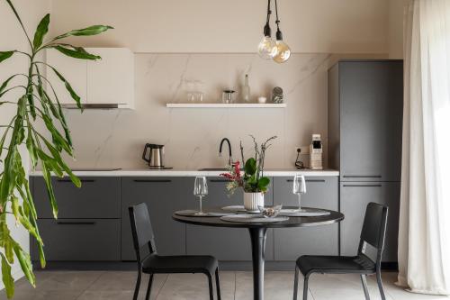 a kitchen with a table and chairs in a kitchen at Tūristu apartamenti in Sigulda