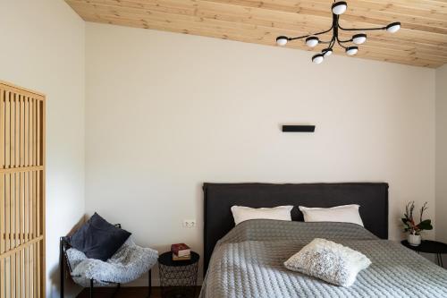 a bedroom with a bed and a wooden ceiling at Tūristu apartamenti in Sigulda