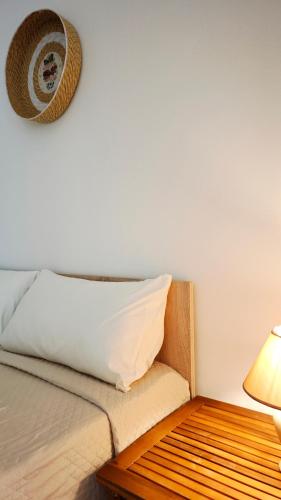 a bedroom with a bed with a pillow and a lamp at Kolossoi Guest House in Càbras