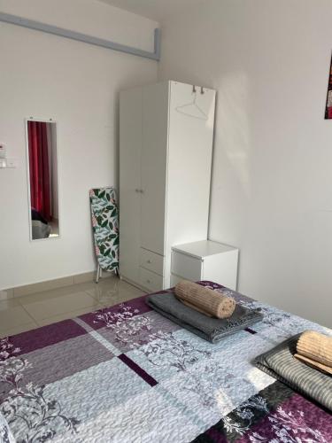 a bedroom with a white cabinet and a rug at My I-go Homestay in Shah Alam