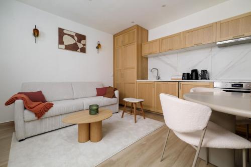 un salon avec un canapé et une table dans l'établissement Modern apartment next to Saint Germain 4PAX, à Paris