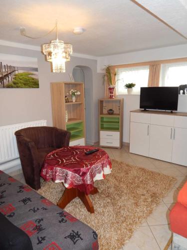 a living room with a table and a couch at Ferienwohnungen Güstrow in Güstrow