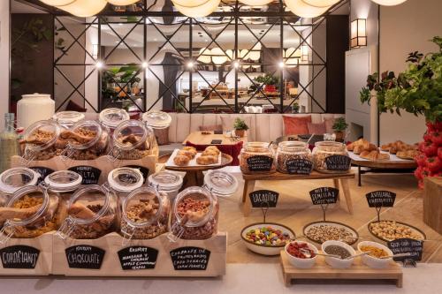 a table with many different types of pastries and other foods at Catalonia Plaza España Hotel & Spa in Madrid