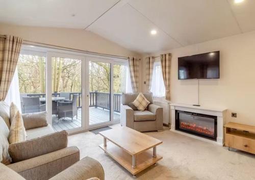 a living room with a couch and a fireplace at Woolverstone Marina and Lodge Park in Ipswich