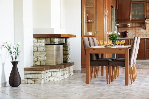 a dining room with a table and a fireplace at Solena in Tsikalariá