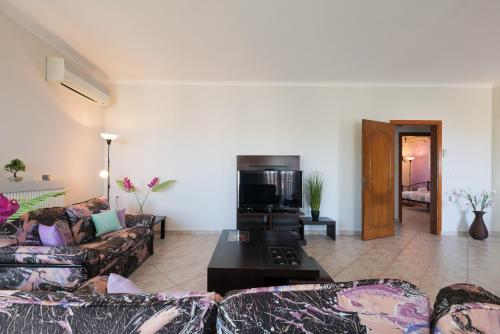 a living room with two couches and a coffee table at Solena in Tsikalariá