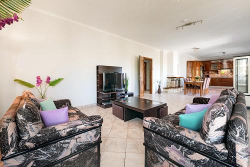 a living room with two couches and a table at Solena in Tsikalariá