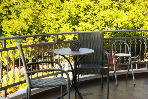 two chairs and a table on a balcony at Solena in Tsikalariá