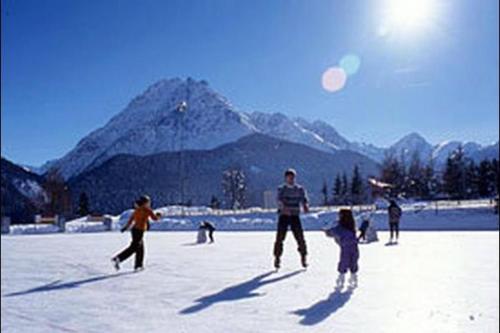 a group of people playing with a kite in the snow at Ancient Engadine Mill in Scuol