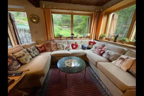 a living room with a couch and a table at Ancient Engadine Mill in Scuol