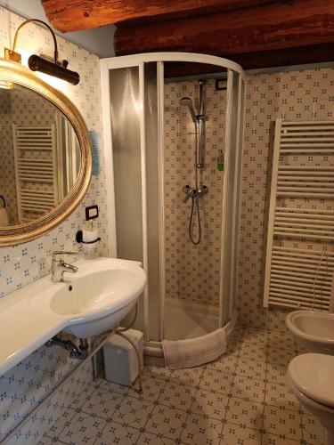 a bathroom with a sink and a shower at Resort Villa Manin in Passariano