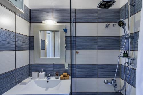 a bathroom with a sink and a shower at Villa Galazopetra in Skopelos Town
