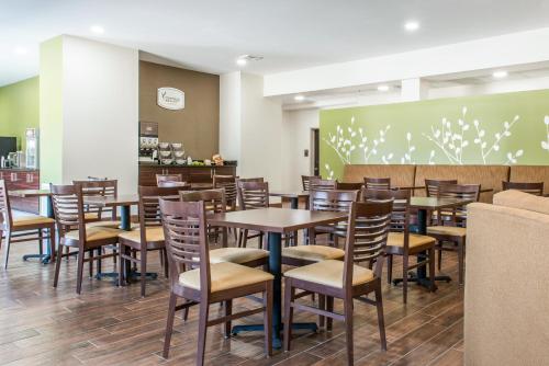 a restaurant with tables and chairs and a greenboard at Sleep Inn Ellenboro Hwy 50 in Ellenboro