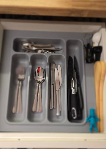 a tray of utensils in a drawer at Morava 1 Asparuhovo Beach Holiday House in Varna City