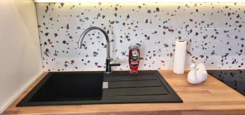 a kitchen sink with a faucet on a counter at Morava 1 Asparuhovo Beach Holiday House in Varna City