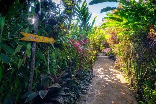 a street sign in the middle of a garden at Hibiscus Valley Inn in Marigot
