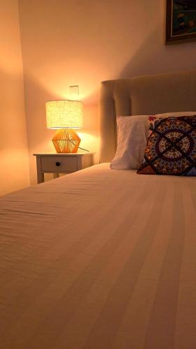 a bedroom with a bed with a lamp on a table at Morava 1 Asparuhovo Beach Holiday House in Varna City