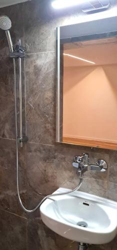 a bathroom with a sink and a shower with a mirror at Morava 1 Asparuhovo Beach Holiday House in Varna City