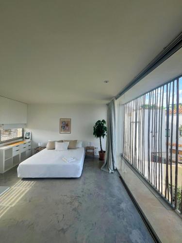 a bedroom with a bed and a large window at Villa Marta in Alicante