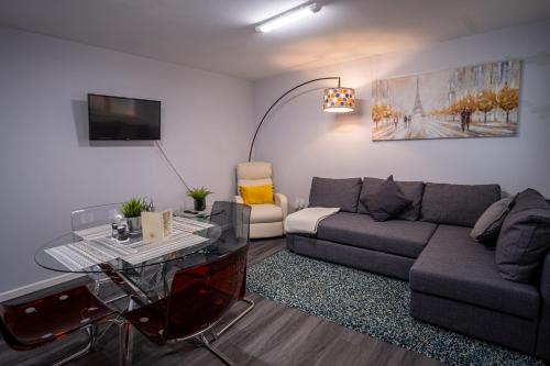 a living room with a couch and a table at 1 Bed-Sleeps 4-Private Garden-Free Parking in St. Albans