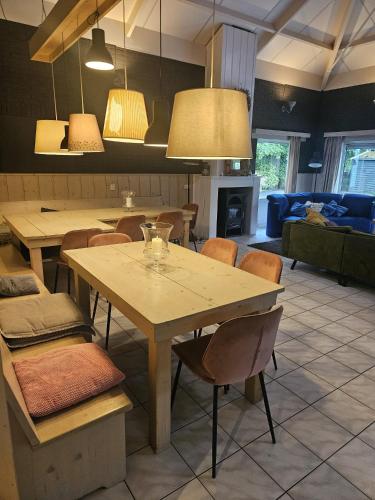 a dining room with a table and chairs at Villa 't Boshuys - a private and green location for families or friends up to 16 guests in Den Ham