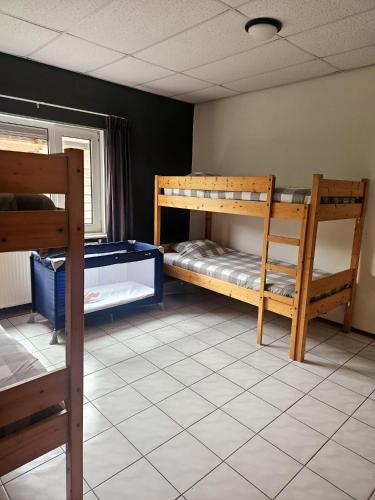a room with two bunk beds and a window at Villa 't Boshuys - a private and green location for families or friends up to 16 guests in Den Ham