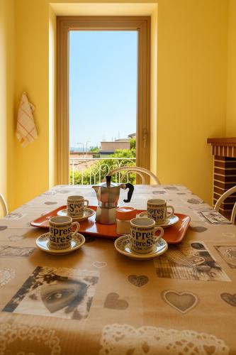 a table with three cups and saucers on it at Casa Tulipano 