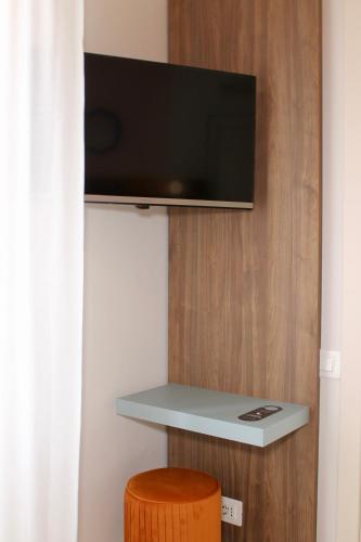 a flat screen tv on a wall in a room at La Vista Postcard Hotel in Lazise