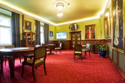 a room with a table and chairs in a room at Pollera in Kraków