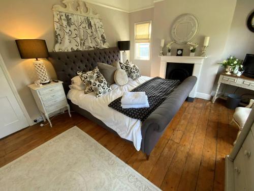 a bedroom with a large bed and a fireplace at Victorian Retreat - A Serene Sanctuary in Broadstairs