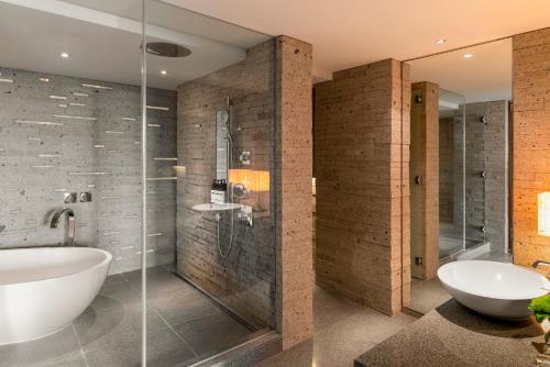 a bathroom with a tub and a shower and a sink at Hyatt Regency Tokyo in Tokyo