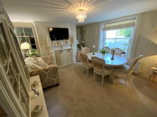 a living room with a table and a couch at Victorian Retreat - A Serene Sanctuary in Broadstairs
