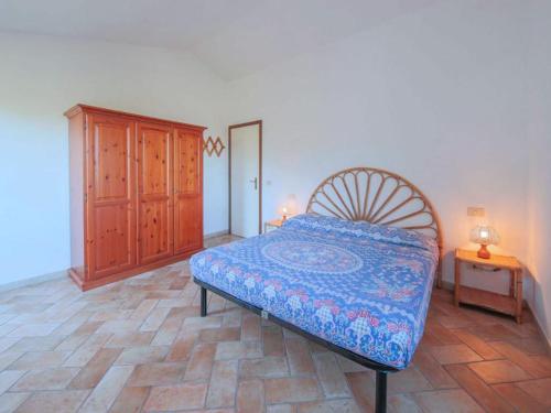 une chambre avec un lit et une armoire en bois dans l'établissement Casa Novella - Argonauti Vacanze, à Procchio