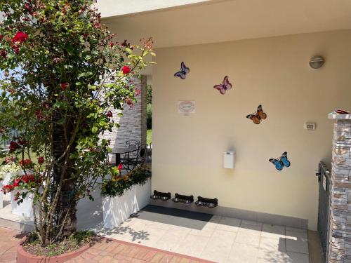 a group of butterflies on the wall of a house at Hotel Panoramica in Bardolino
