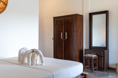 Ein Bett oder Betten in einem Zimmer der Unterkunft Ethera Arugam bay