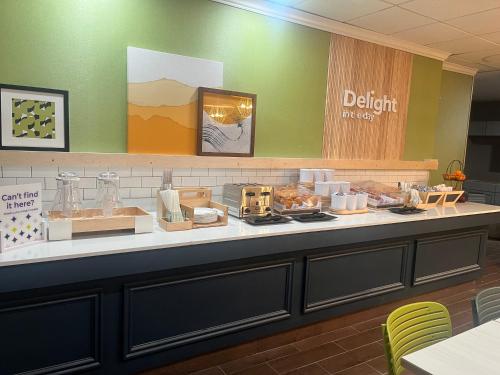 a bakery counter with a buffet of food on it at Spark by Hilton Lockport in Lockport