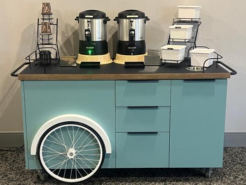 a blue cart with two coffee machines on it at Spark by Hilton Lockport in Lockport