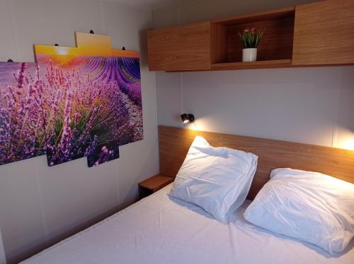 a bedroom with a bed and a painting on the wall at Douce Provence - Provence Cote d'Azur in Vidauban