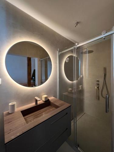 une salle de bain avec un lavabo et un miroir dans l'établissement Au coeur de Montmartre, à Paris